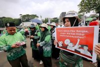 Para guru madrasah swasta yang tergabung dalam Perkumpulan Guru Madrasah (PGM) Indonesia menggelar aksi di depan Gedung DPR/MPR RI, Senayan, Jakarta Pusat, Rabu (11/2/2026). 