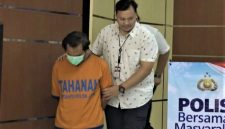 Polisi menggiring tersangka pembunuhan ibu dan anak di Kota Madiun berinisial DBM (40) di Mapolda Jatim, Surabaya